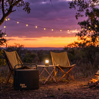 Two chairs around a campfire with a sunset in the background